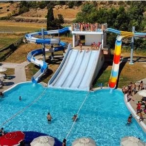 a water park with a slide in a pool at Domus de Jara - Casa Montis in Baradili