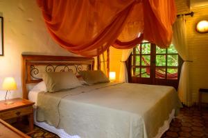 a bedroom with a bed and a window at Pousada Vila Serrano in Lençóis