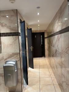 a bathroom with a urinal and a glass door at Le Relais De La Poste in Pithiviers +22 photos