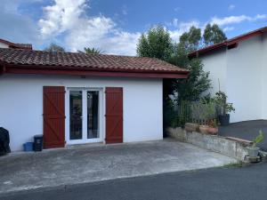 a small white garage with a door at Kayola 2 in Saint-Jean-de-Luz