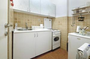 a kitchen with a sink and a washing machine at Cozy apartment near Saint Sava Temple in Belgrade