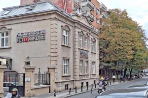 a building with a sign on the side of a street at Cozy apartment near Saint Sava Temple in Belgrade