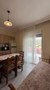 a dining room with a table and chairs and a kitchen at Sikia Luxury Apartments in Sikia