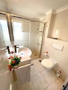 a bathroom with a shower and a toilet and a sink at Tropicalife in Playa del Ingles