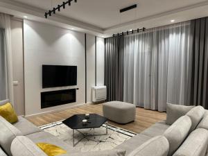 a living room with a couch and a tv at CD Villa in Golem