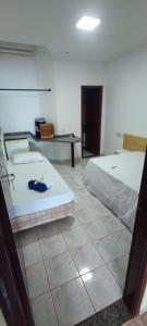 Rúm í herbergi á Hotel Marambaia Ponta Porã