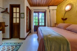 a bedroom with a bed and a window at Pousada Vila Serrano in Lençóis