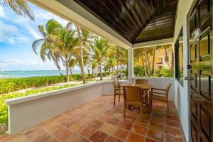a porch with a table and chairs and the ocean at Tradewinds Paradise Villas in San Pedro +53 photos