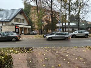 a group of cars parked on the side of a street at Apartament Suceava in Suceava