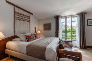 a bedroom with a large bed and a window at Villa Kerasy Hotel Spa in Vannes