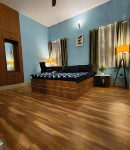a bedroom with a bed and a wooden floor at Flickstays Blossom in Bangalore +12 photos