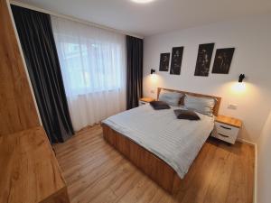 a bedroom with a bed and a large window at Apartament Suceava in Suceava