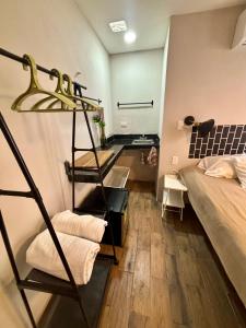 a room with a bunk bed and a ladder next to a bed at Casa Ufemia in Mérida