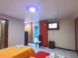 Postel nebo postele na pokoji v ubytování Hostal Flor de los Angeles Salcedo