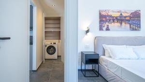 a bedroom with a bed and a washing machine at EasyTopStay - Gelsomino Charming Flat in Rome