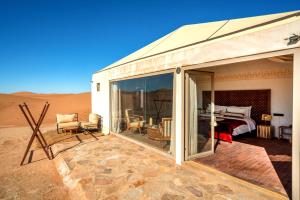 a building in the middle of the desert at Ghazala Camp - Luxury Erg Chigaga Magic in Mhamid