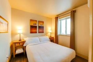 a bedroom with a large white bed and a window at La Familliale 69 - 3 chambres - 7 personnes in Saint-Férréol-les-Neiges +14 photos