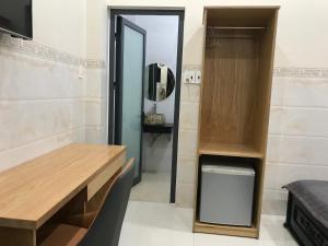 a dressing room with a vanity and a mirror at Thiên Các Hotel in Quy Nhon