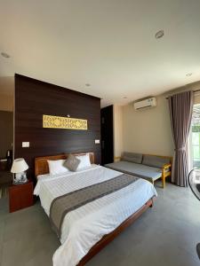a large bedroom with a large bed and a window at B&H Villa - Villa has swimming pool in Lang Co