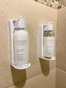 two bottles of soap on the wall of a bathroom at Pousada Vila Serrano in Lençóis