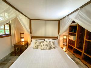 a bedroom with a bed with a canopy at Pousada Vila Serrano in Lençóis