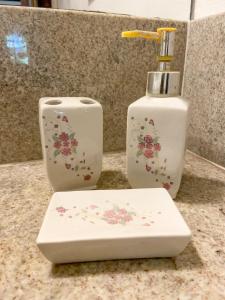 two white vases are sitting on a counter at Pousada Vila Serrano in Lençóis
