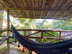 a hammock on top of a wooden porch at Pousada Vila Serrano in Lençóis