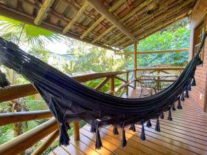 a hammock on a porch of a house at Pousada Vila Serrano in Lençóis