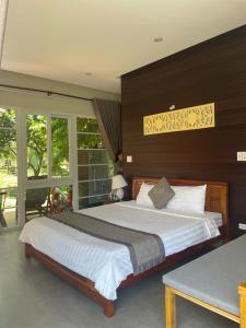 a bedroom with a large bed and a large window at B&H Villa - Villa has swimming pool in Lang Co