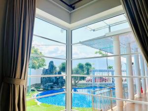 a view of a pool from a room with a window at B&H Villa - Villa has swimming pool in Lang Co