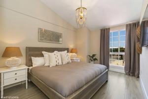a bedroom with a large bed and a window at Mariners 212 Great Location with Marina Views in Key Largo +39 photos