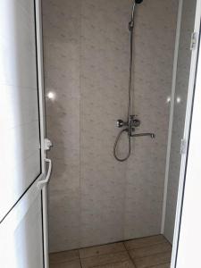 a shower stall with a shower head in a bathroom at Yurt camp Visit Kol-Suu in Kol-Suu