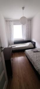 Postel nebo postele na pokoji v ubytování Uroczy Apartament