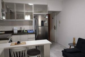 a kitchen with a stainless steel refrigerator and a counter at Espaço especial IX in Curitiba