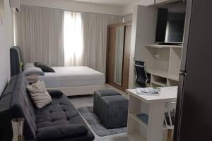 a living room with a couch and a bed at Espaço especial IX in Curitiba