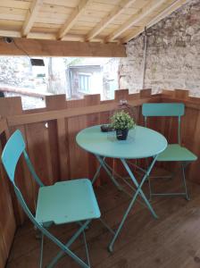 a table and two chairs in a room at Le pigeonnier d'Agnès in Jenzat