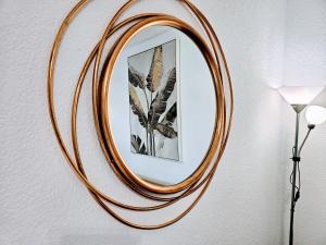 a wooden mirror hanging on a wall with a lamp at Top Flor Ocean View in Playa del Cura +60 photos