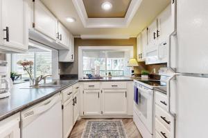 a kitchen with white cabinets and a window at Anchorage 7473 in Hilton Head Island