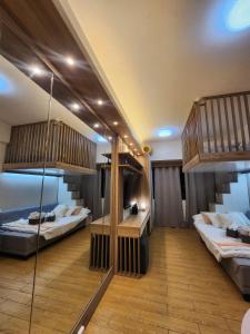 two bunk beds in a room with wooden floors at Nordic Rsquare Manila - with Pool Access in Manila +146 photos
