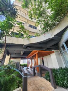 a building with a table and chairs in front of it at Nordic Rsquare Manila - with Pool Access in Manila