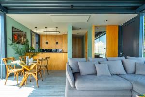 a living room with a couch and a table at Loft na wodzie - Bogaczewo in Bogaczewo