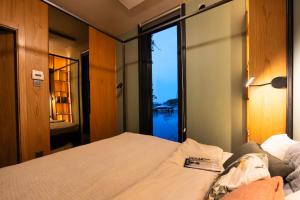 a bedroom with a bed with a view of the water at Loft na wodzie - Bogaczewo in Bogaczewo