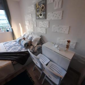a bedroom with a bed and a desk and two chairs at Studio Apartment with Pool View, Sunny Beach in Sunny Beach