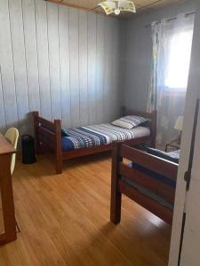 a small room with a bed and a window at Chez Ti Roland et Josie in Le Tampon