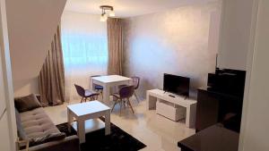 a living room with a couch and a table with chairs at Apartamenty Chęciny in Chęciny