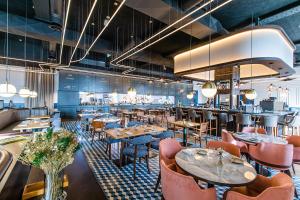 a restaurant with tables and chairs and a bar at The Editory Riverside Hotel, an Historic Hotel in Lisbon