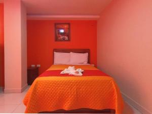 Postel nebo postele na pokoji v ubytování Hostal Flor de los Angeles Salcedo