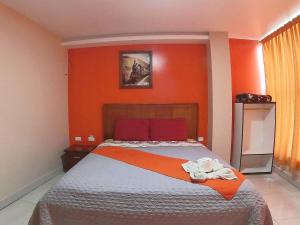 Postel nebo postele na pokoji v ubytování Hostal Flor de los Angeles Salcedo