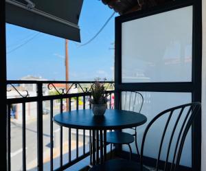 a table with a potted plant on a balcony at Selena Boutique in Neos Marmaras