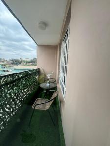 a balcony with a table and chairs on a building at The O Apartment in Ongata Rongai 